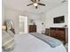 View of main bedroom featuring a king bed, large mirror, and ensuite bathroom at 11912 Richmond Trl, Parrish, FL 34219