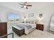 Bright main bedroom featuring a king-size bed, a large window, and neutral decor at 11912 Richmond Trl, Parrish, FL 34219