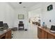 Open floor plan with tiled floors connecting office space, dining area, and kitchen at 11912 Richmond Trl, Parrish, FL 34219