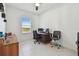 A clean, well lit office space with tile floors, multiple monitors, and a view to the outside at 11912 Richmond Trl, Parrish, FL 34219