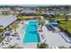 Aerial shot showcasing a pool, surrounded by palm trees, lounge chairs and sunshades at 11912 Richmond Trl, Parrish, FL 34219