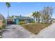 Charming exterior view of home featuring lush landscaping, covered parking, and a cozy porch at 120 148Th E Ave, Madeira Beach, FL 33708