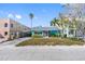 Charming, light-blue single-story home features a covered carport and verdant landscaping at 120 148Th E Ave, Madeira Beach, FL 33708