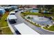 Aerial view of neighborhood with covered parking, pond, and tennis court at 14511 Catalina Cir # 14511, Seminole, FL 33776