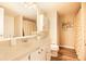 Bright bathroom with a large mirror, white vanity and cabinets and wood-look flooring at 14511 Catalina Cir # 14511, Seminole, FL 33776