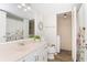 Well-lit bathroom features wood-look floors, white cabinets and a closet with washer at 14511 Catalina Cir # 14511, Seminole, FL 33776