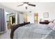 Bedroom featuring wood-look flooring, ceiling fan, and sliding glass doors to a balcony at 14511 Catalina Cir # 14511, Seminole, FL 33776