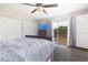 Bright bedroom with a ceiling fan, sliding glass doors to a balcony, and laminate floors at 14511 Catalina Cir # 14511, Seminole, FL 33776