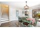 Bright dining area with stylish table set, decor, lighting fixture, and staircase access offering a welcoming and comfortable ambiance at 14511 Catalina Cir # 14511, Seminole, FL 33776