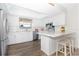 Bright kitchen featuring white cabinets, stainless steel appliances, and granite countertops at 14511 Catalina Cir # 14511, Seminole, FL 33776