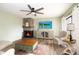 Inviting living room featuring a stone fireplace, modern ceiling fan, and tasteful furnishings for a cozy and stylish retreat at 14511 Catalina Cir # 14511, Seminole, FL 33776