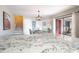 Open concept living space with kitchen island, dining area, and access to a private patio at 14511 Catalina Cir # 14511, Seminole, FL 33776