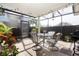 Relaxing screened lanai with dining set, grill, string lights, and lush greenery at 14511 Catalina Cir # 14511, Seminole, FL 33776