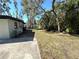 Expansive backyard featuring a grassy lawn, mature trees, and plenty of space for outdoor activities at 1501 Howard Pl, Largo, FL 33770