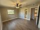 Bedroom featuring wood-look floors, natural light, and entry to the en-suite bathroom and kitchen at 1501 Howard Pl, Largo, FL 33770