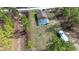 Aerial view of home with screened pool, RV, surrounded by mature trees and lush landscaping at 15429 Green Jay Rd, Weeki Wachee, FL 34614