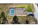 Aerial view of the backyard with a screened pool, RV parking and landscaped yard at 15429 Green Jay Rd, Weeki Wachee, FL 34614