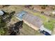 Aerial view of home with screened pool, landscaped yard, and RV Parking at 15429 Green Jay Rd, Weeki Wachee, FL 34614