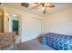 This bedroom includes a ceiling fan, a closet with sliding doors, and neutral carpeting at 15429 Green Jay Rd, Weeki Wachee, FL 34614
