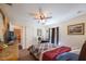 Bedroom featuring a ceiling fan, comfortable bed, and closet with a view to another room at 15429 Green Jay Rd, Weeki Wachee, FL 34614