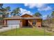Charming single Gathering home featuring a two-car garage and manicured lawn at 15429 Green Jay Rd, Weeki Wachee, FL 34614