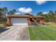 Well-maintained home featuring a spacious driveway and a fenced-in yard at 15429 Green Jay Rd, Weeki Wachee, FL 34614