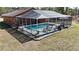 A screened-in pool with patio furniture, with an eye-level view for relaxation and fun at 15429 Green Jay Rd, Weeki Wachee, FL 34614