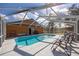 Sparkling screened-in pool with lounge chairs, perfect for relaxation and entertainment at 15429 Green Jay Rd, Weeki Wachee, FL 34614