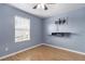 Bedroom featuring a mounted entertainment center, window with blinds and a ceiling fan at 17533 Stinchar Dr, Land O Lakes, FL 34638