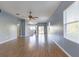 Bright and airy living room with wood floors and an open floor plan leading to the kitchen at 17533 Stinchar Dr, Land O Lakes, FL 34638