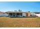 Expansive backyard with a screened-in porch, offering outdoor living and entertaining space at 18350 Burkholder Cir, Port Charlotte, FL 33948