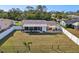 Fenced backyard featuring lush green grass and an outdoor patio at 18350 Burkholder Cir, Port Charlotte, FL 33948
