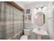 Neat bathroom featuring vanity lights, a round mirror, and shower at 18350 Burkholder Cir, Port Charlotte, FL 33948