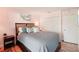 Comfortable bedroom featuring wood floors, a cozy bed, and closet at 18350 Burkholder Cir, Port Charlotte, FL 33948