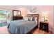 Bedroom showcasing a bed, dresser, and view to the outdoors at 18350 Burkholder Cir, Port Charlotte, FL 33948