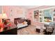 Pink Bedroom with a crib, dresser, rocker, and built-in shelves at 18350 Burkholder Cir, Port Charlotte, FL 33948