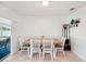 Cozy dining area features a wooden table with seating for four and a view of the outdoor screened porch at 18350 Burkholder Cir, Port Charlotte, FL 33948