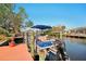 Dockside view with boat, offering convenient access to the water and scenic waterfront living at 18350 Burkholder Cir, Port Charlotte, FL 33948