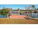 Waterfront home featuring a private dock with boat access and picturesque water views at 18350 Burkholder Cir, Port Charlotte, FL 33948