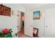 Playroom hallway features an open door, art, and wood floors at 18350 Burkholder Cir, Port Charlotte, FL 33948