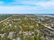 An aerial view of a complex surrounded by trees with a lake in the background at 2218 Portofino Pl # 246, Palm Harbor, FL 34683