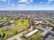 Low-rise apartments and condos with a nearby green golf course and mature tree canopy at 2280 World Parkway Blvd # 34, Clearwater, FL 33763