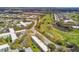 Low-rise condos surrounding a golf course with a waterway, mature landscaping, and open parking at 2280 World Parkway Blvd # 34, Clearwater, FL 33763