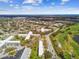 A community of low-rise condos adjacent to a golf course with green trees and lush landscaping at 2280 World Parkway Blvd # 34, Clearwater, FL 33763