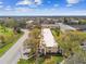 Long low-rise condo with mature trees, open parking, and an inviting entrance at 2280 World Parkway Blvd # 34, Clearwater, FL 33763