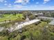 Multi-unit condo near a manicured golf course with lush green trees and landscaping at 2280 World Parkway Blvd # 34, Clearwater, FL 33763