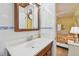 Bathroom with tiled walls, wood-trimmed vanity, and open doorway to the bedroom at 2280 World Parkway Blvd # 34, Clearwater, FL 33763