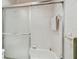 Close-up of the shower inside of the tidy bathroom featuring tiling and a glass sliding door at 2280 World Parkway Blvd # 34, Clearwater, FL 33763