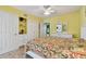 Bright bedroom features built-in storage and white furniture, with a floral bedspread at 2280 World Parkway Blvd # 34, Clearwater, FL 33763