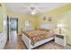 Bright bedroom with white furnishings, floral bedding, ceiling fan, and decorative wall art at 2280 World Parkway Blvd # 34, Clearwater, FL 33763